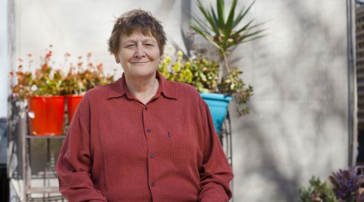 A woman sitting and smiling